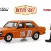 1970 Datsun 510 4-Door Sedan With Race Car Driver, Orange - Greenlight 97070D/48 - 1/64 Diecast Car